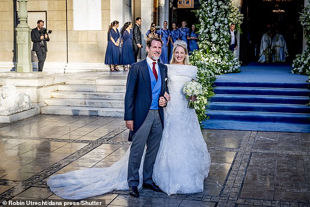 Princess Theodora of Greece and Crown Prince Pavlos pose for photos outside the venue