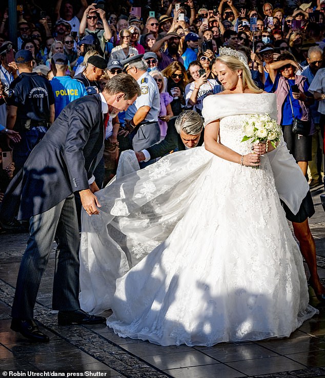 In no time, Crown Prince Pavlos tried on the bride's Celia Kritharioti dress