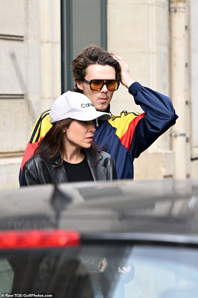 While his Brazilian singer girlfriend Jackie also opted for a casual style, donning a black leather jacket, teamed with a black top and a white sports cap