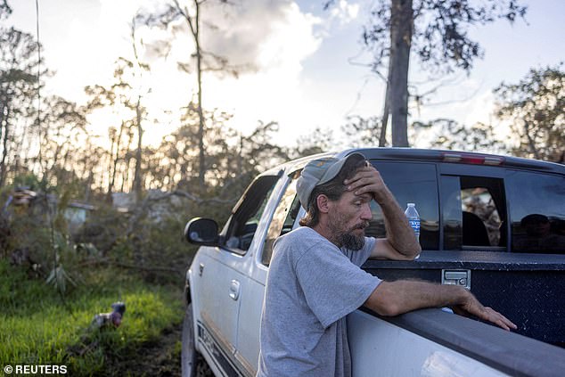 Matthew Harris leans on the bed of his truck after Hurricane Helene destroyed the home where he lived in Steinhatchee, Florida