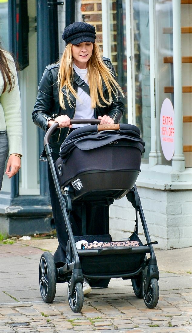 She was first photographed pregnant in June as she walked the red carpet at the Into Film Awards in London (Pictured: Pushing her newborn in Berkshire)