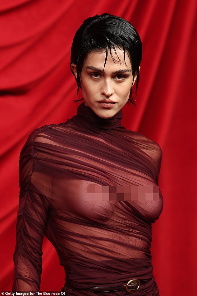 Meanwhile, Amelia dared to bare as she went braless at the fashion event, exposing her bare breasts under a sheer burgundy dress.