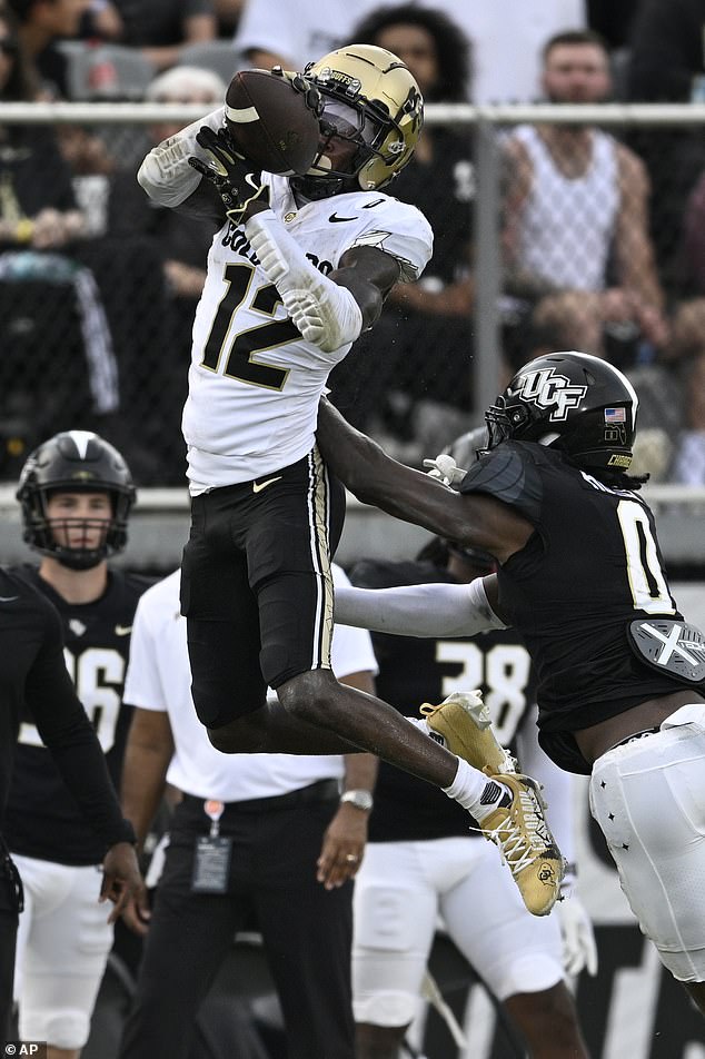 Hunter (12) catches a pass as Central Florida defensive back Brandon Adams (0) defends