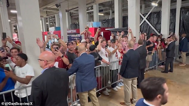 The Secret Service set up catwalks for Trump to get in and out, while at times he was swamped by watching and cheering fans.