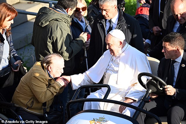 Pope Francis greets the audience as he meets students and members of the Catholic University of Leuven during his three-day visit to Louvain-la-Neuve, Belgium