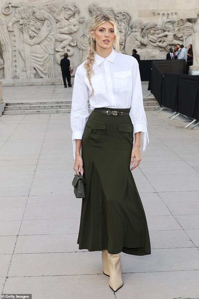 She teamed her look with a small black designer bag and a thin belt that cinched her waist