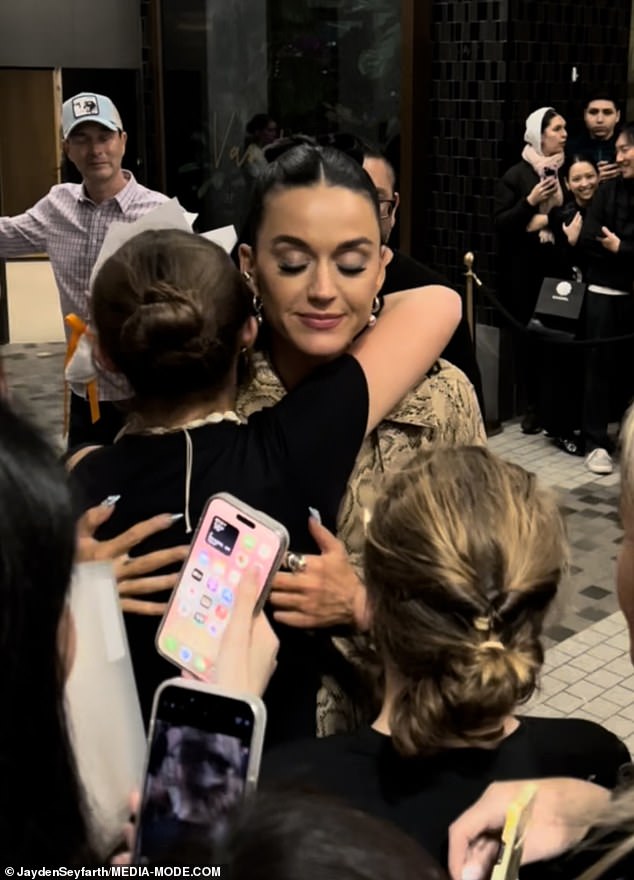 The I Kissed A Girl hitmaker was seen affectionately hugging a young fan in a sweet moment as crowds gathered outside her hotel