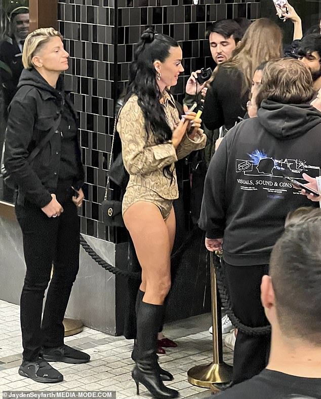 Katy put on a very leggy display in leopard print hot pants and a matching collared top as she greeted her delighted fans outside the hotel