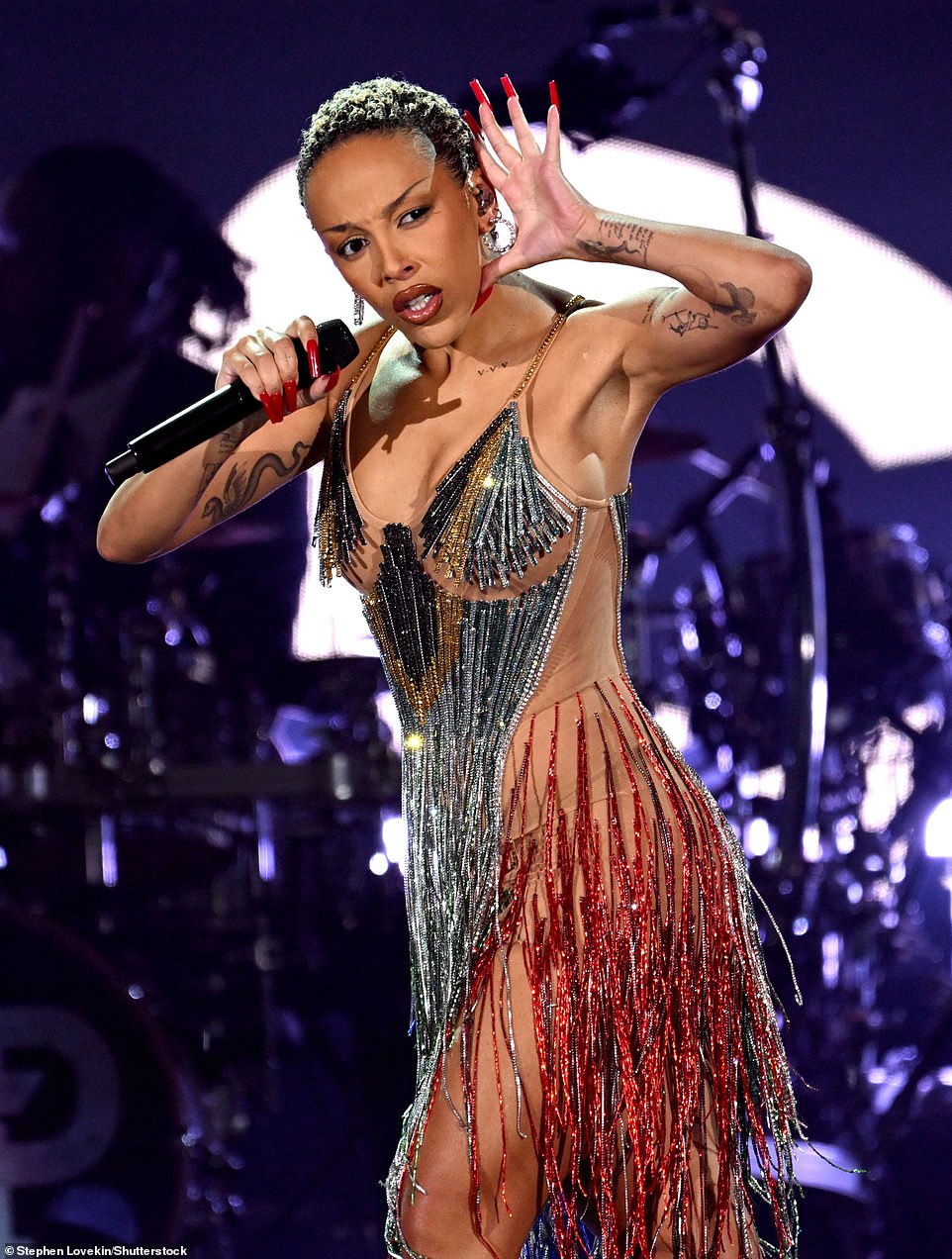 The 28-year-old music artist lit up the stage as she modeled a low-cut, nude dress with sequin-covered fringe during her performance