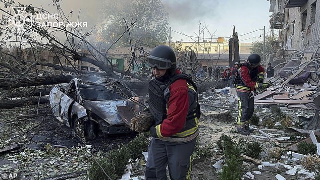 Ukrainian emergency services workers clear the rubble after Russia attacked the city with guided bombs on Sunday, September 29, in Zaporizhia, Ukraine.