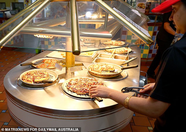 The heated buffet station features freshly baked pizzas