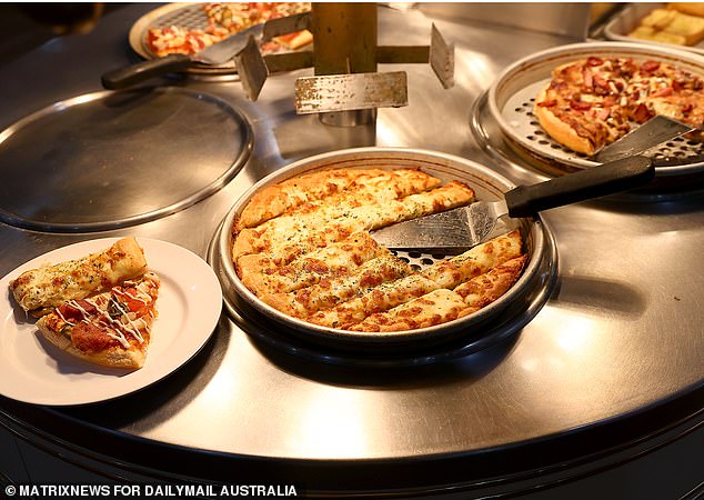 While smorgasbord dining has largely fallen out of fashion in Australia, Mr Ahuia's Pizza Hut restaurant continues to not only survive, but thrive