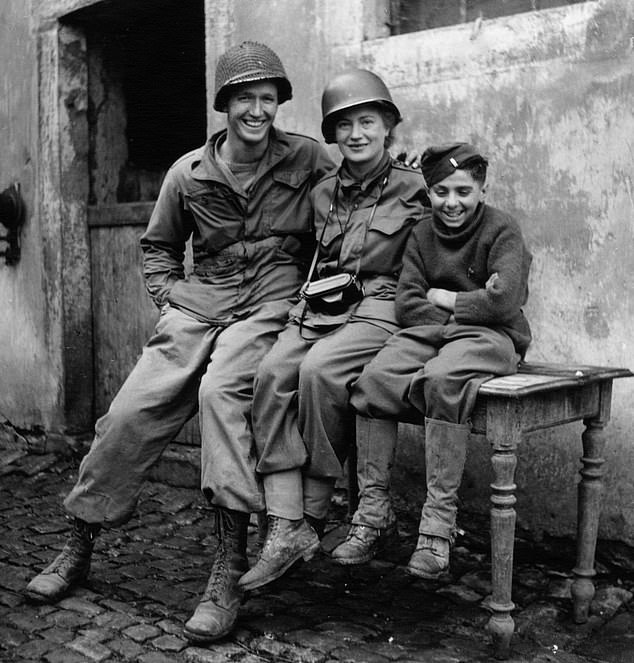 Lee Miller with two American soldiers in a shot entitled 'Me with the smallest and the tallest'