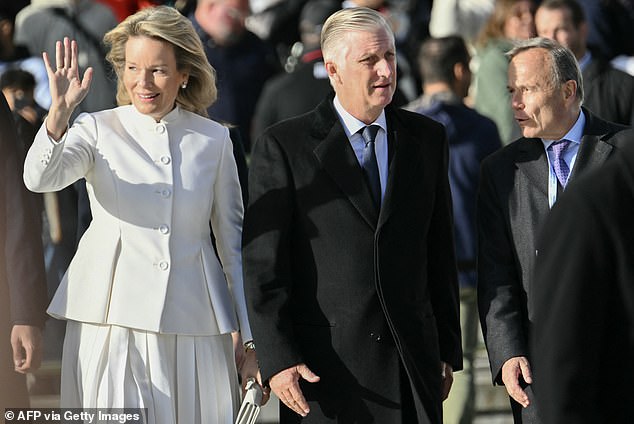 Also in attendance was Queen Mathilde's husband, King Philip (to the Queen's right) of Belgium, who complemented his wife's all-white ensemble by wearing an all-black suit and tie.