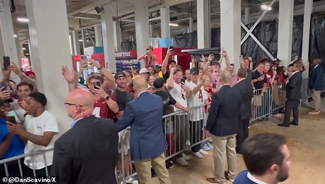 The Secret Service set up catwalks for Trump to get in and out, while at times he was swamped by watching and cheering fans.