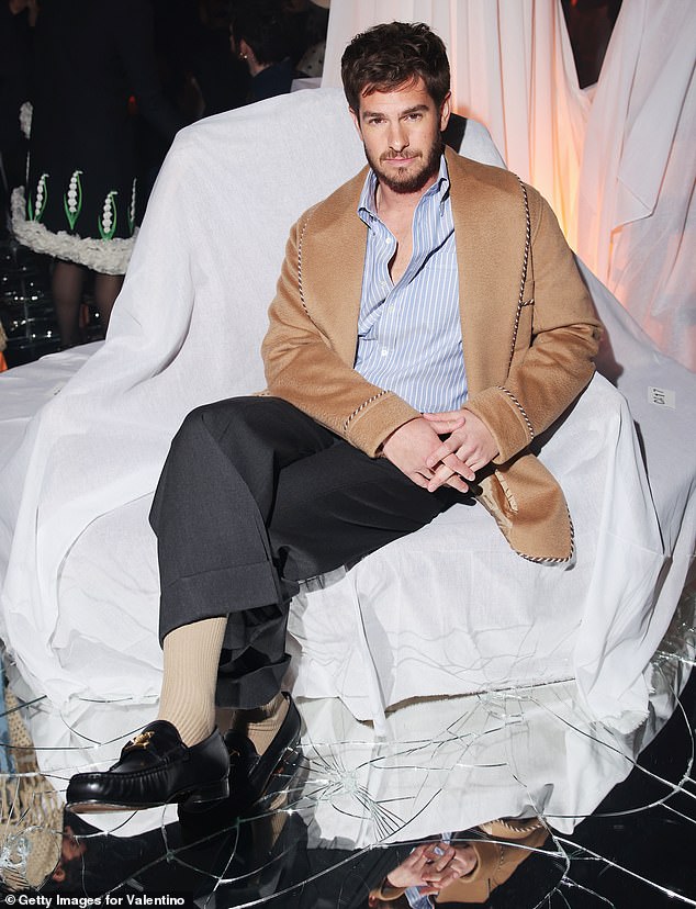 He posed at the FROW before the catwalk show started