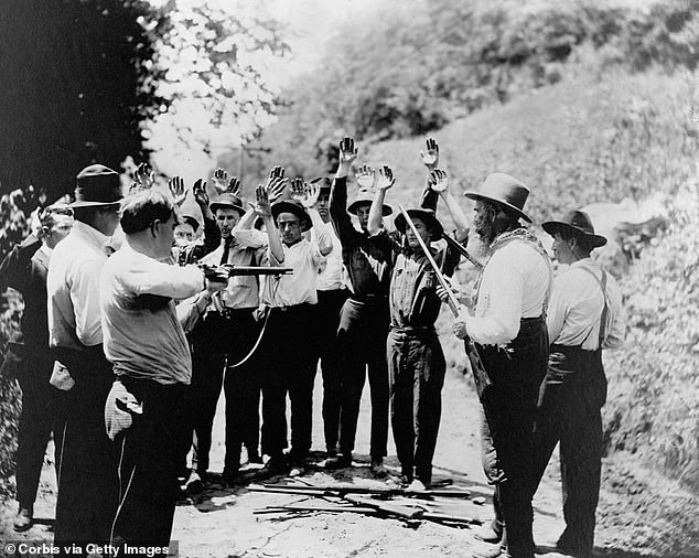 Pictured above is a group of Hatfield gunmen, late 19th century, stopping men, possibly McCoys, along the road