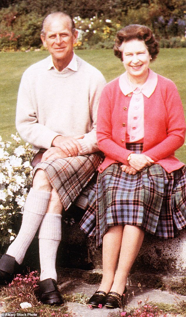 The late Queen and her husband Prince Philip are pictured here next to Balmoral's flower walk