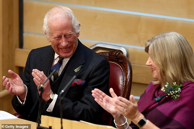 King Charles smiles as he talks to Presiding Officer Alison Johnstone