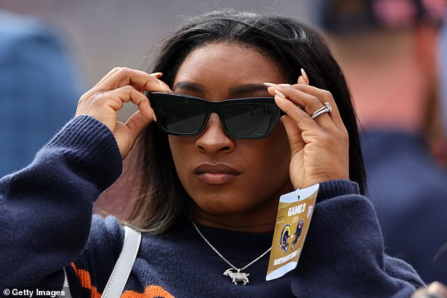 Biles wore dark sunglasses as she watched the match before her show on Sunday night