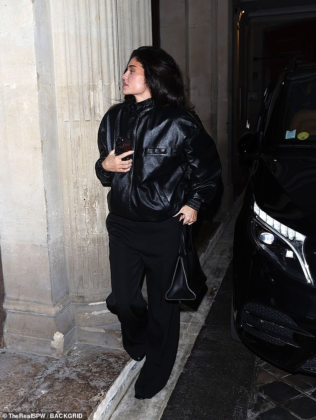 The Kylie Cosmetics mogul, 27, wore a black leather bomber jacket by designer Phoebe Philo over a black turtleneck and black pants