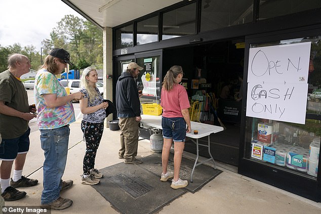 People wait in line at Dollar General in the aftermath of Hurricane Helene