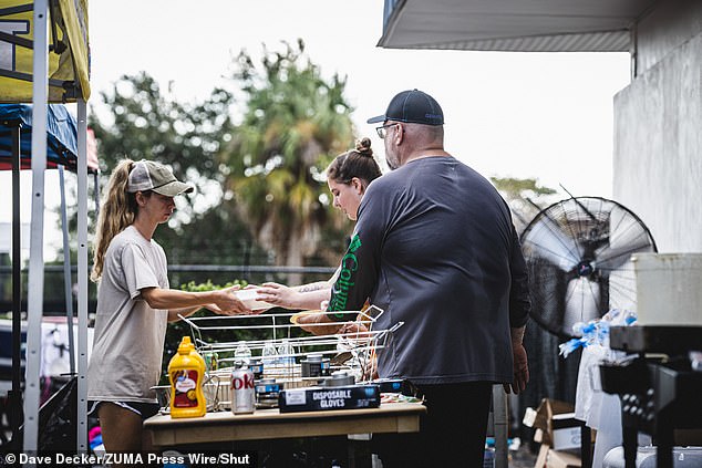 Residents feed people at the mutual aid site hosted by Shady Hills Little League in the Town of Hudson