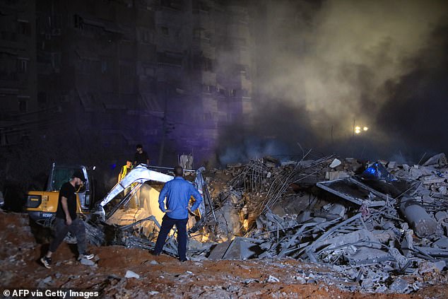 First responders and civilians use a difference to clear rubble after an airstrike in Haret Hreik, southern Beirut on September 27