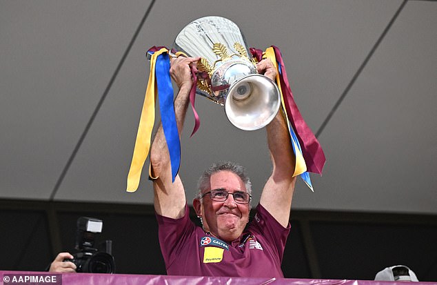 Lions coach Chris Fagan proudly hoists the 2024 premiership cup at Brisbane's Springfield fan day on Sunday afternoon