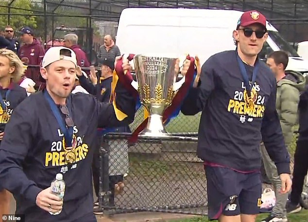 After a heavy night of celebration, Lachie Neale (left) and Josh Dunkley appeared at Brunswick Street Oval on Sunday morning with the 2024 trophy intact