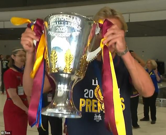 Brisbane Lions young gun Kai Lohmann proudly displayed the trophy at Brisbane Airport as they returned home on Sunday