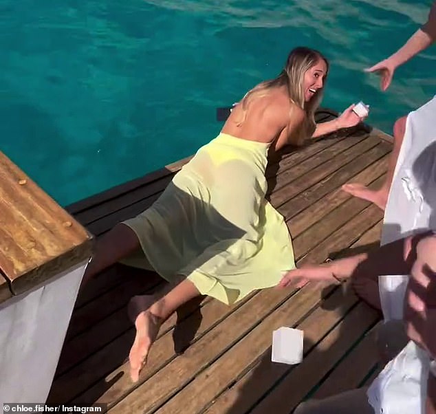 DJ Fisher and his wife Chloe shared a clip of the heartbreaking moment the bridesmaid dropped one of the rings overboard after the couple's three-month-old daughter Bobbi 'helped' her mother carry the boxes to the wedding party.