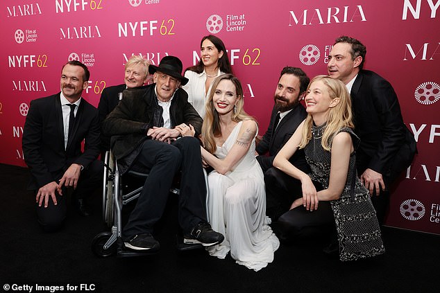 Jolie happily posed with the cast and crew