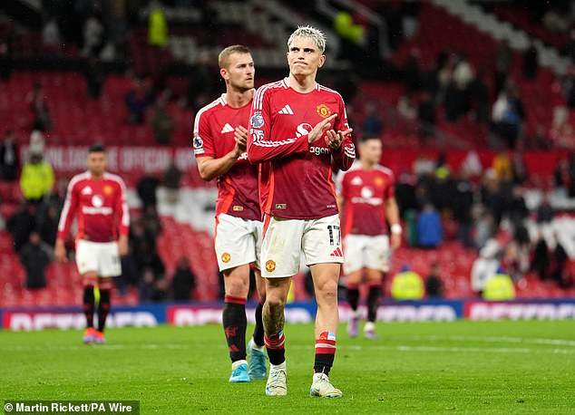 Alejandro Garnacho (front) and Matthijs de Ligt pictured applauding the fans as he walked away