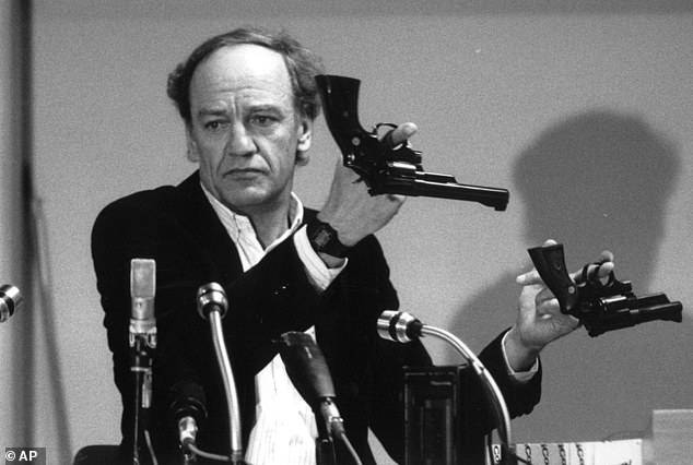 Hans Holmer, former head of the investigation into the assassination of Swedish Prime Minister Olof Palme, shows two Smith & Wesson .357 Magnum revolvers during a press conference in Stockholm