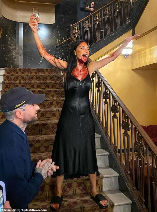 Nicole, still dripping in fake blood and wearing her long black dress, raised a glass of champagne as she celebrated her opening night in New York City.