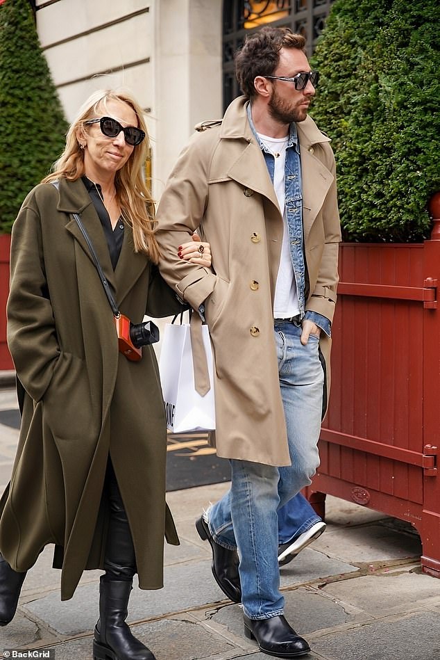 Sam looks chic in a khaki green jacket and black boots, while Aaron wears double denim under his stylish trench coat