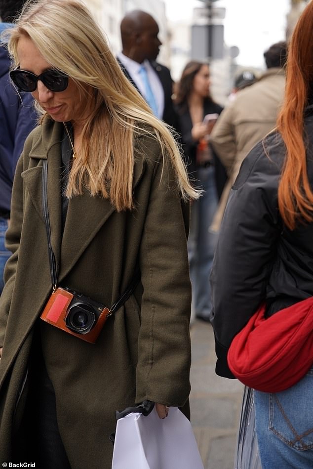 Trying to keep a low profile, Sam shielded her eyes with dark-rimmed sunglasses