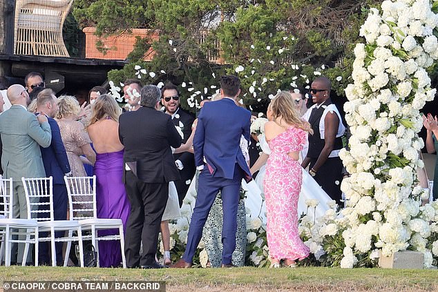 Rebel and Ramona's family and friends - including former TOWIE star Vas J Morgan - showered Rebel with confetti as they walked down the aisle