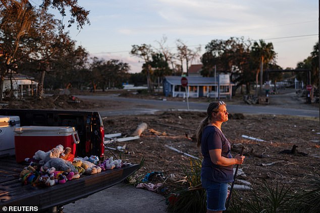 Paula Williams helps a friend clean up a flooded house in Steinhatchee, Florida