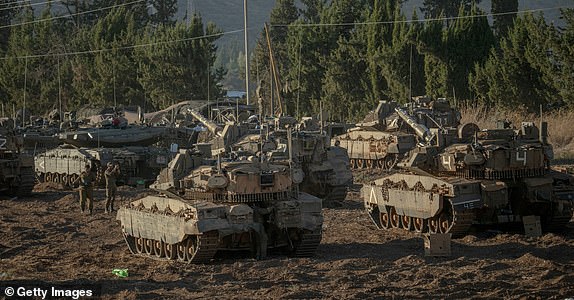 ISRAEL - LEBANESE BORDER, UPPER GALILEE, - SEPTEMBER 30: Israeli tanks and APCs gather at the Israeli - Lebanese border on September 30, 2024. Amid Israel's escalating campaign against Hezbollah in Lebanon, speculation about a possible ground offensive continues. Last week, Israeli Chief of Staff Lieutenant General Herzi Halevi said Israel's recent airstrikes were intended to "prepare the way for your possible entry and to continue to humiliate Hezbollah." (Photo by Erik Marmor/Getty Images)