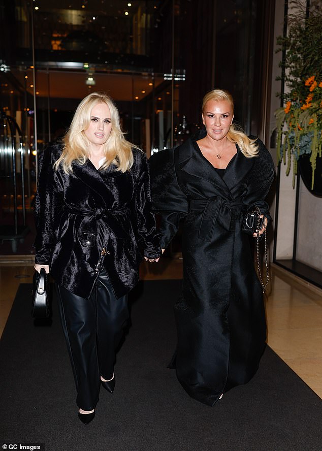 The couple dressed in matching black and held hands as they left their hotel