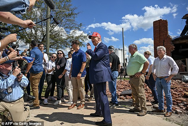 Former US president and Republican presidential candidate Donald Trump looks at the aftermath of Hurricane Helene