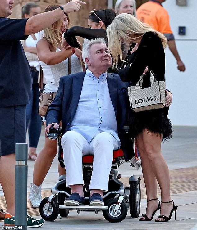 Eamonn Holmes pats her bum as they spend an evening in Ibiza.