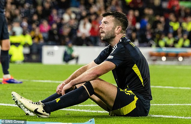 Grant Hanley was left dejected after his rash tackle gave Poland the winning penalty