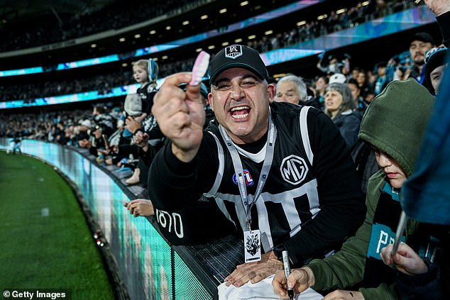 Qantas has added an extra flight at 10am on Friday for Port Adelaide fans to travel to Sydney ahead of the preliminary final. Pictured: A Port Adelaide fan