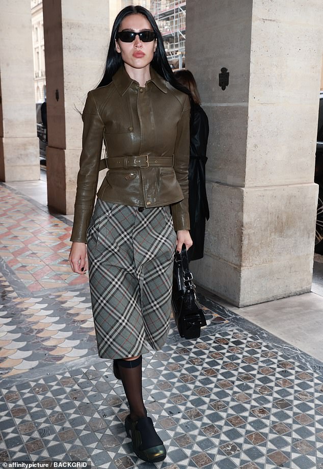 Amelia Gray Hamlin, 23, rocked an olive green leather jacket and a gray plaid skirt on Wednesday as she headed out for dinner in Paris