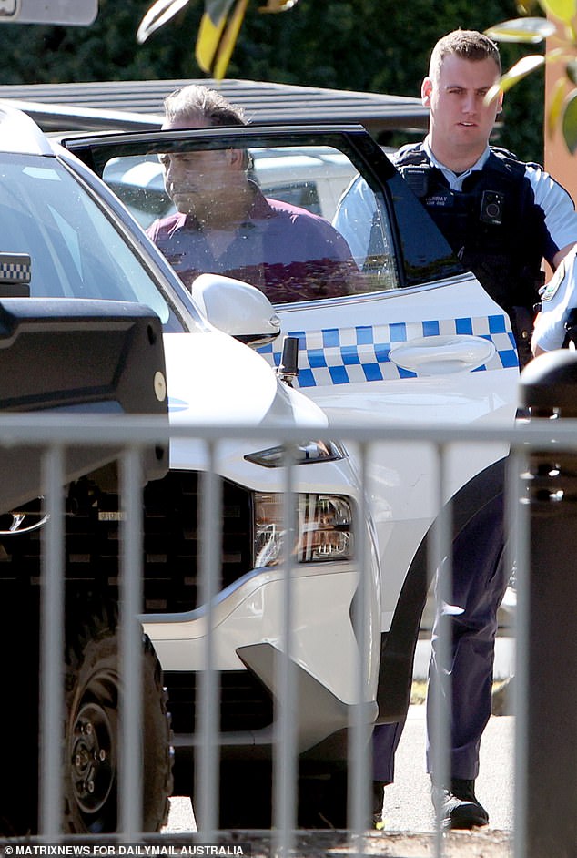 O'Keefe was then seen walking out the rear exit of the station, accompanied by three officers wearing latex gloves who took him away in the back of a police car.