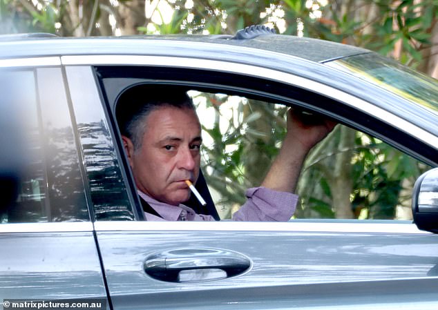 Andrew O'Keefe looked somber on Wednesday as he was spotted picking up a mystery woman in his car in Sydney's upmarket suburb of Point Piper. Pictured