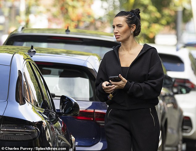 Annie Kilner put on a brave face as she kept it casual in a black tracksuit while out and about in Wilmslow on Monday